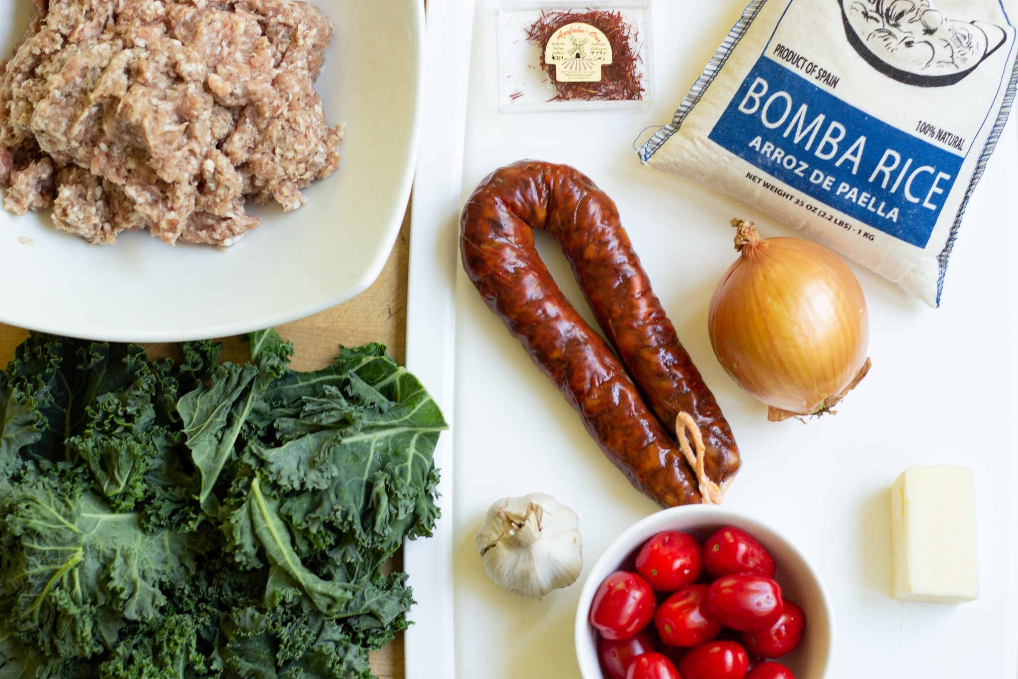 ingredients list chicken sausage, chorizo, saffron, bomba rice, kale, onion, garlic, tomato, chicken stock