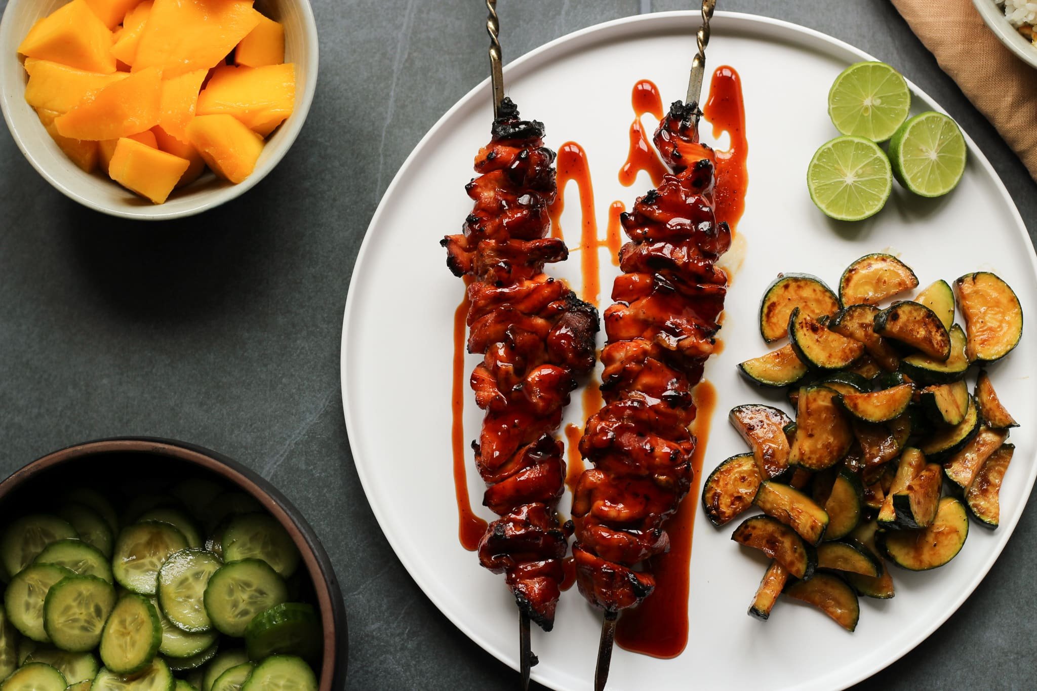 bbq chicken skewer with zucchini, rice, lime, mango