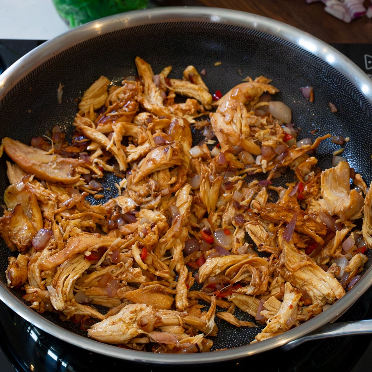 Chicken sisig tossed and coated in calamansi, Maggi, and oyster sauce until sizzling