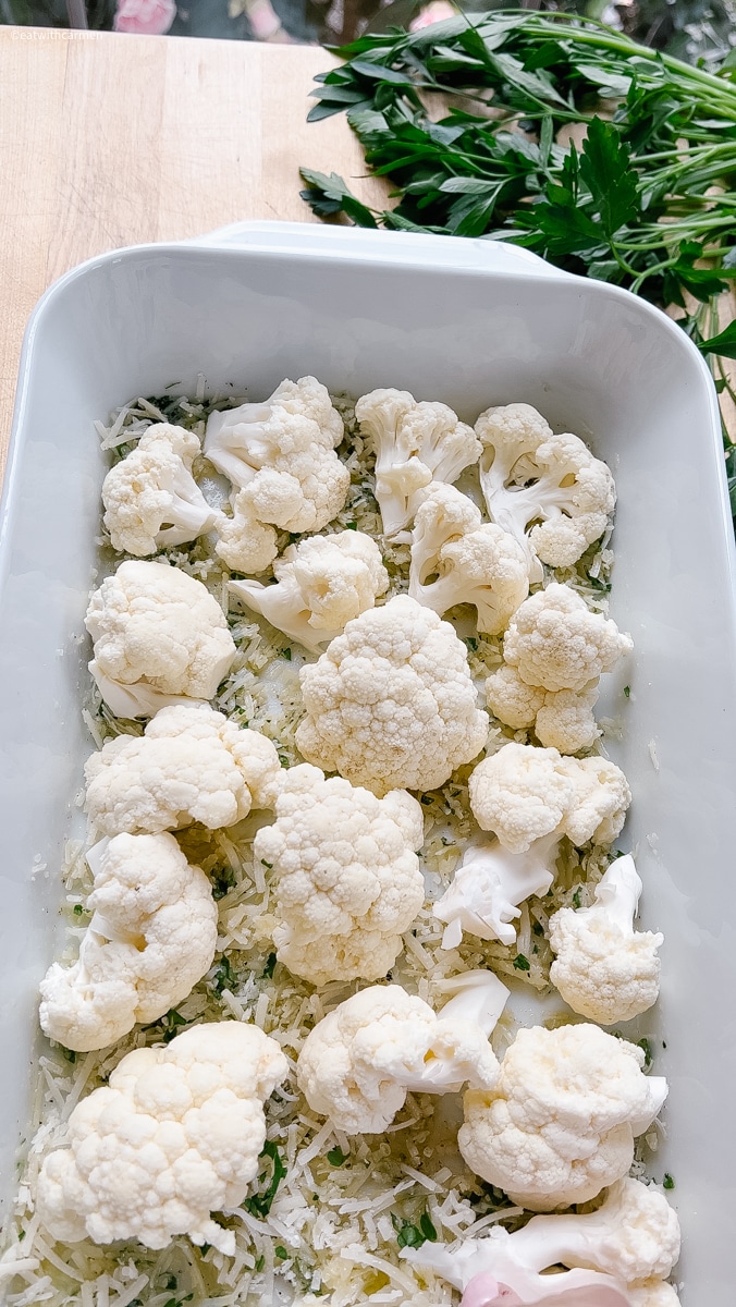 cauliflower recipe, spread out parmesan cheese with parsley, olive oil, salt and pepper. Add cauliflower florets
