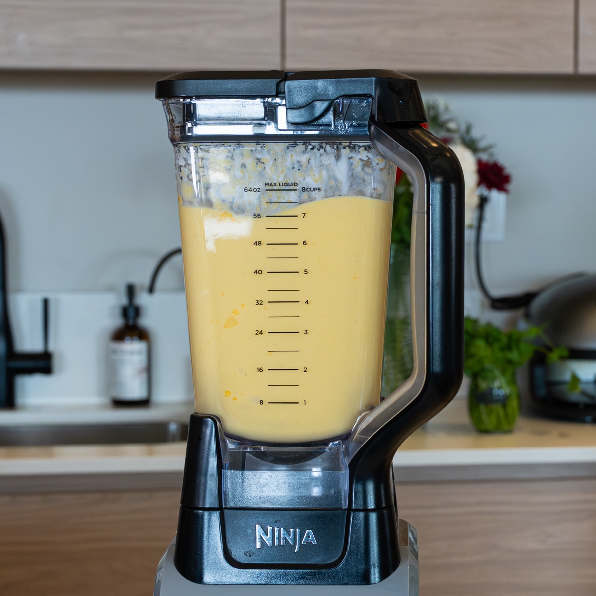 Fresh mango blended with coconut milk and condensed milk in a blender