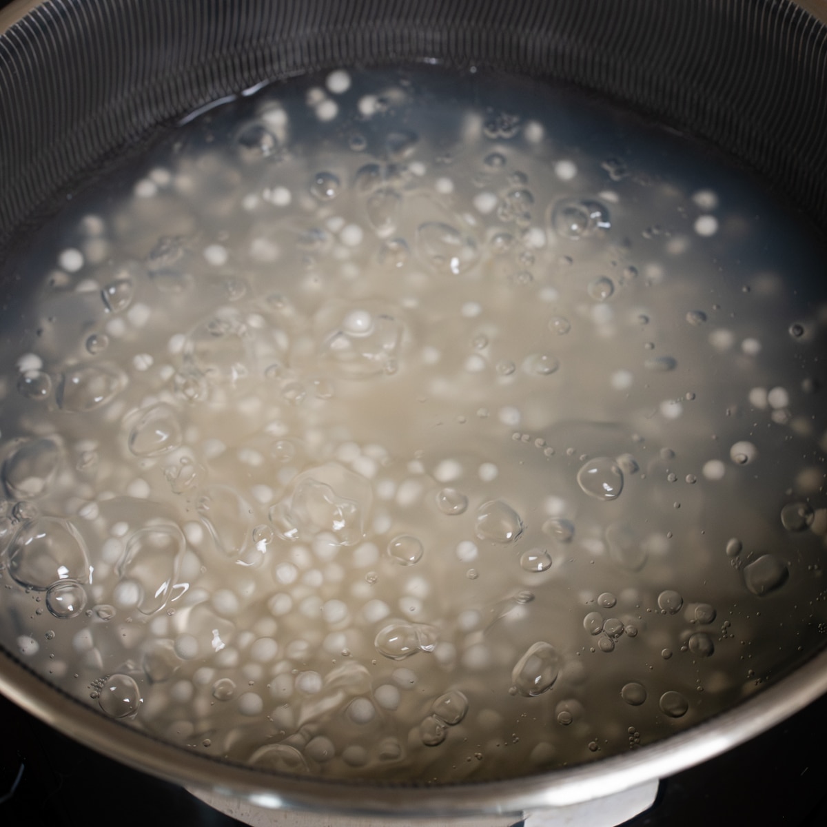 Sago pearls boiling in a pot until translucent for mango sago