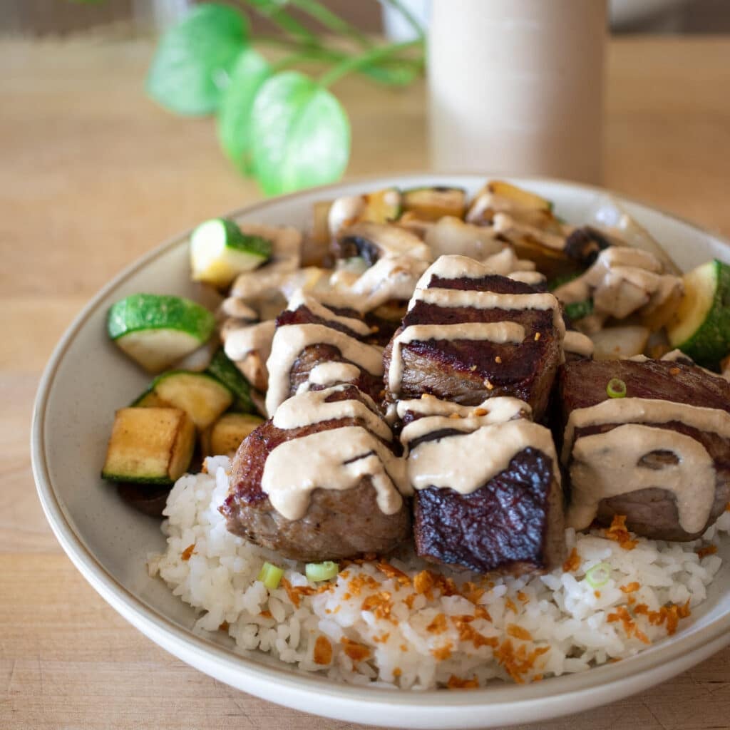 hibachi bowl with rice, crispy garlic, sauteed vegetables.