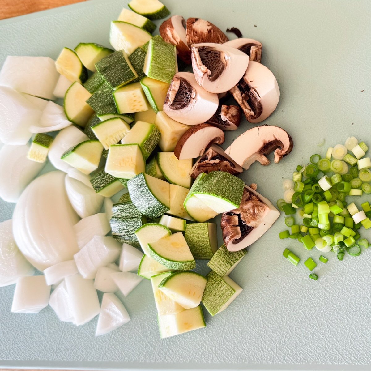chopped vegetables like zucchini, mushrooms and onions.