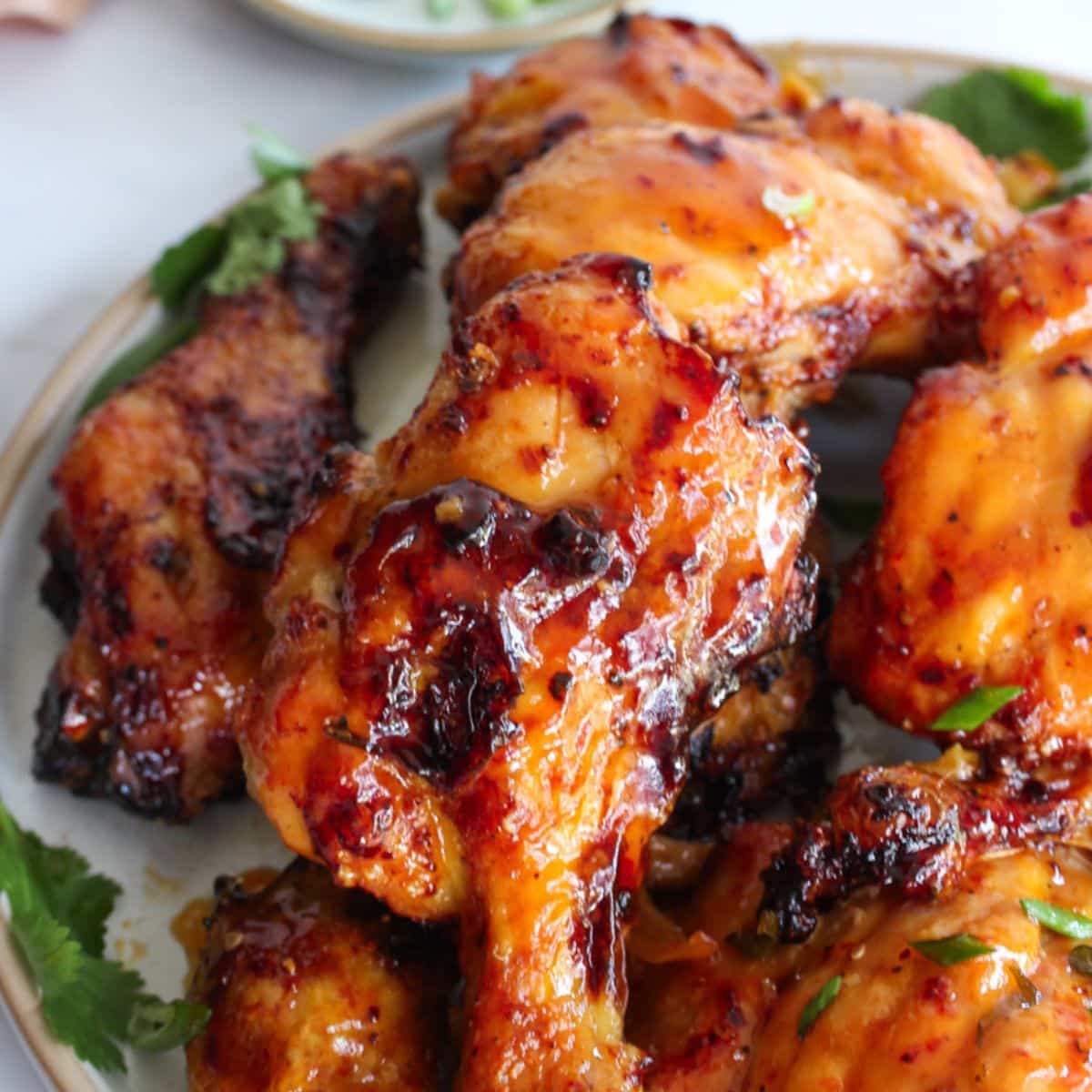 orange ginger chicken drumsticks on plate, football party recipes