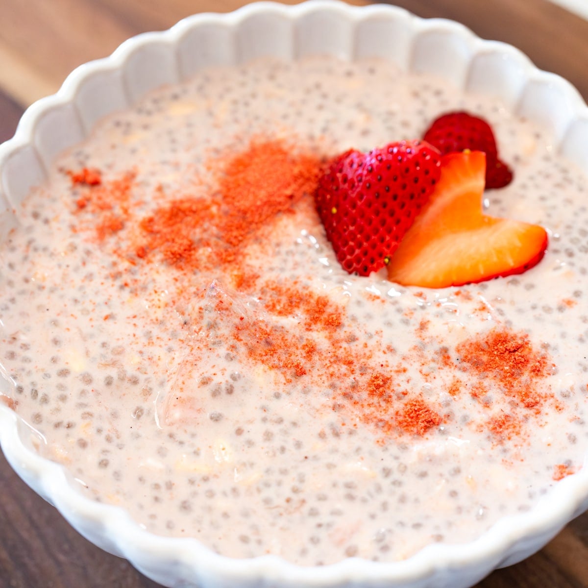 strawberries and cream overniht oats chilled and ready to serve with fresh strawberry slices on top