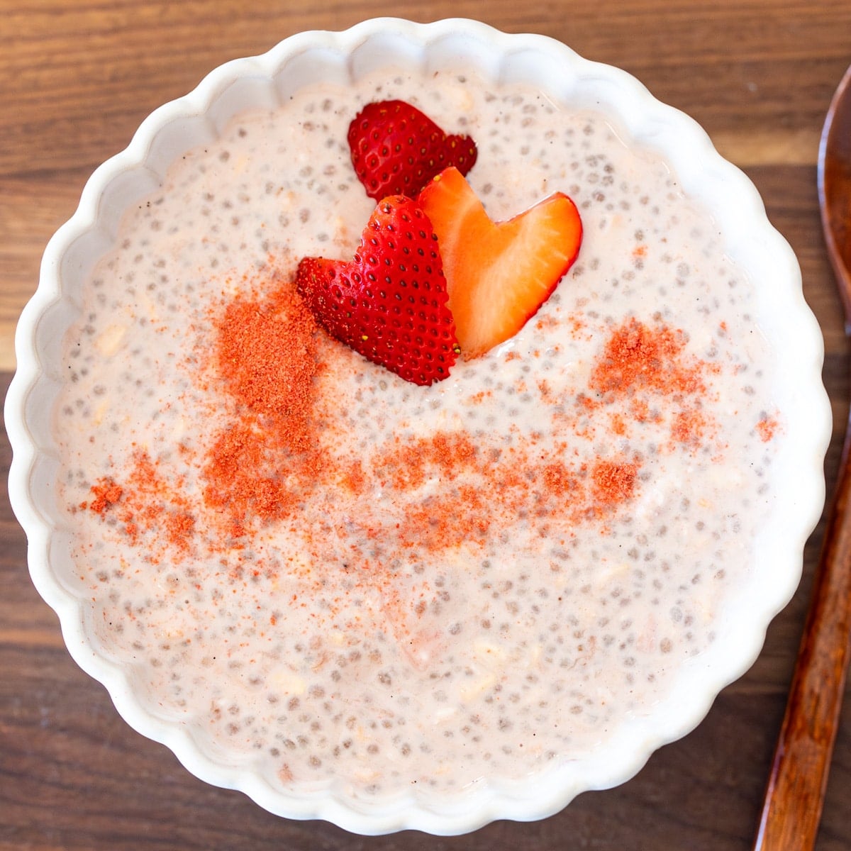 strawberries and oat overnight oats with homemade strawberry compote swirled in and topped with fresh cut strawberries