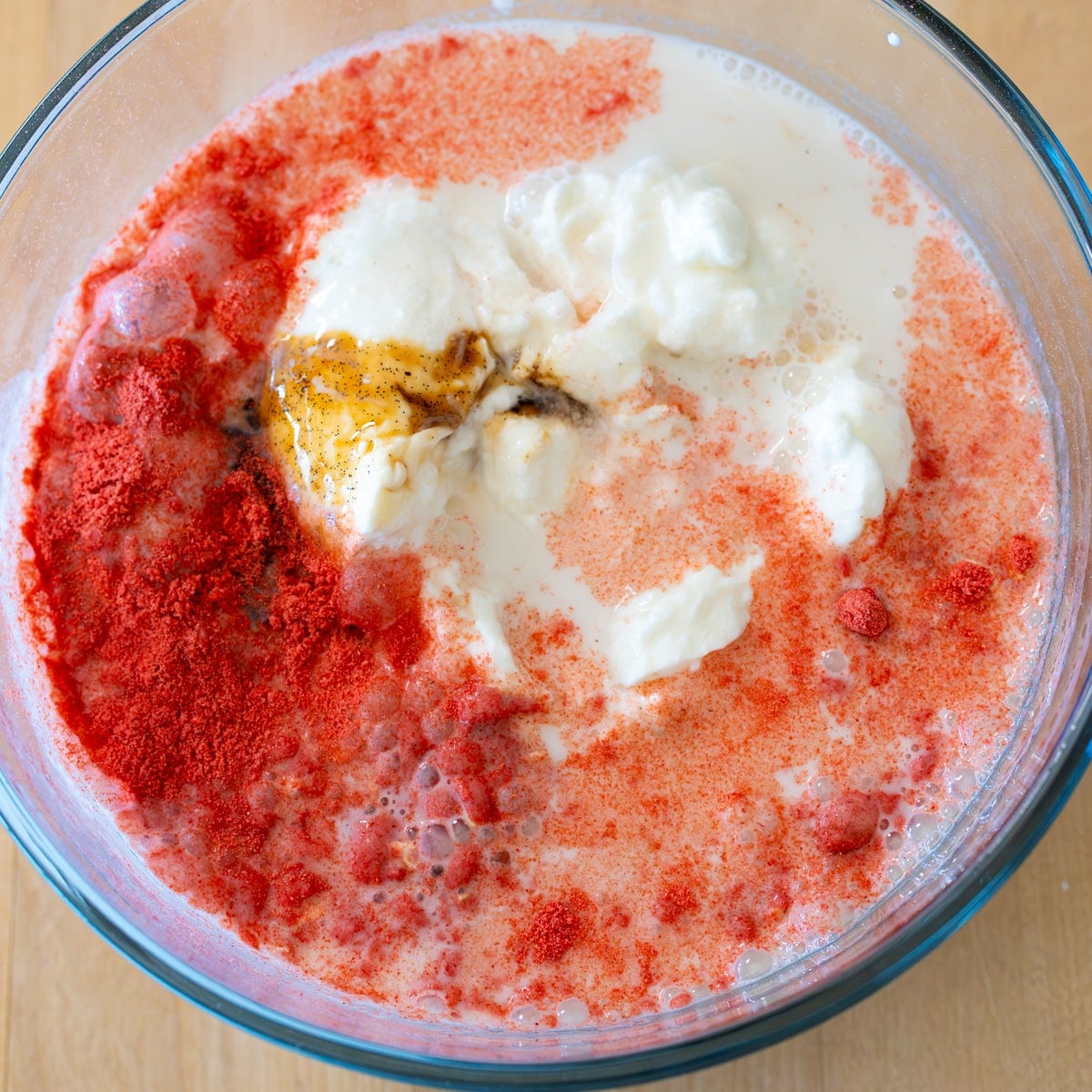 mixing in oat base for easy strawberries and cream overnight oats with homemade compote