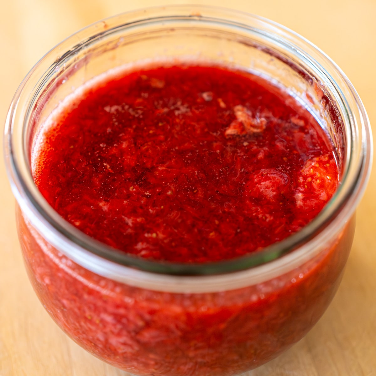 homemade strawberry compote in glass jar ready to use or store