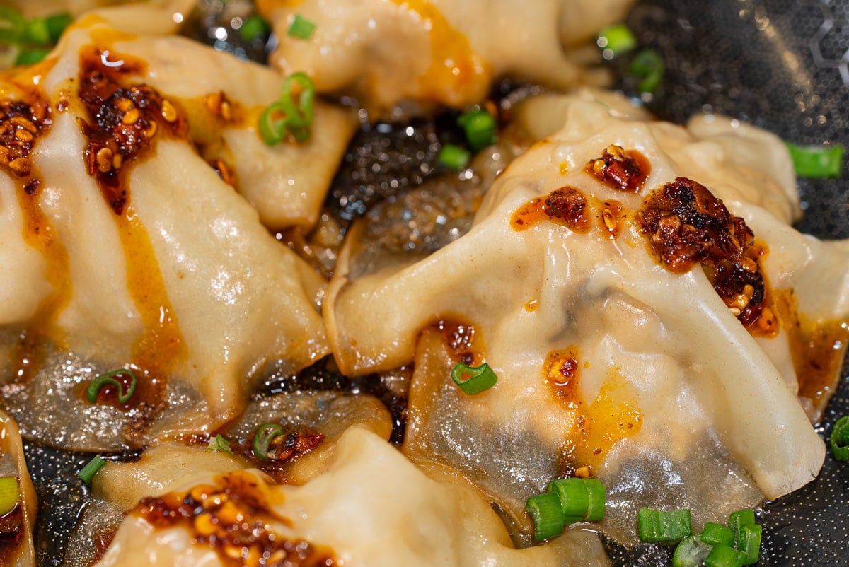 no fold dumplings topped with green onion and homemade dumpling sauce