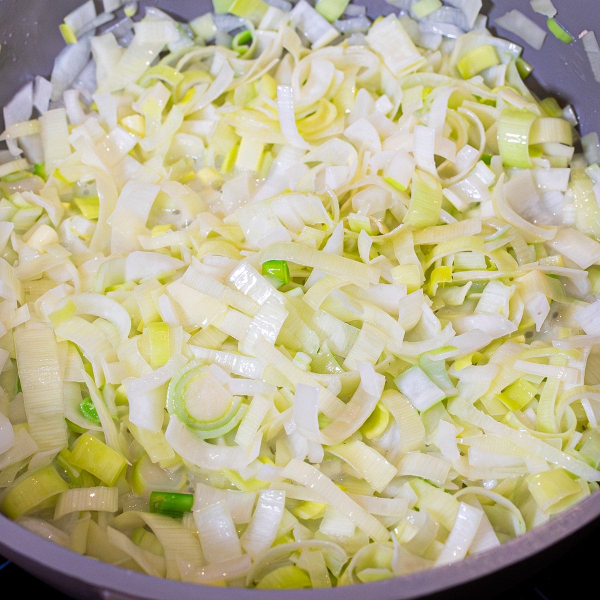 adding in leeks, carrots and onion for skillet chicken pot pie with puff pastry