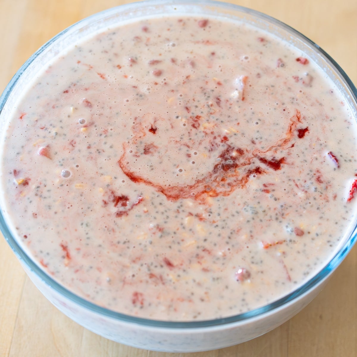 swirling in the homemade compote for strawberry and cream overnight oats