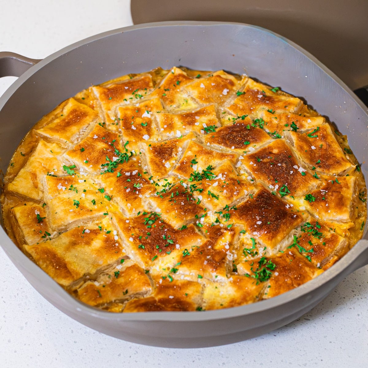 skillet chicken pot pie with leeks and puff pastry ready to serve