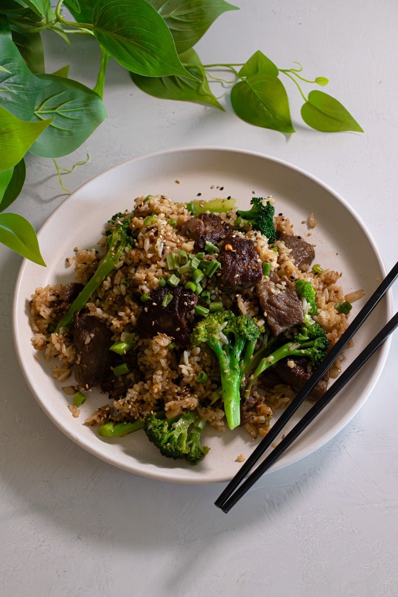 beef and broccoli plated topped with sesame and green onion