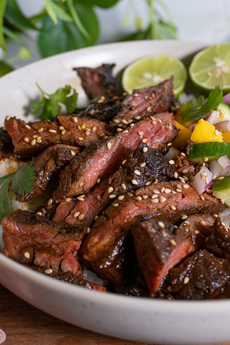 freshly plated asian marinated skirt steak over cilantro rice and served with side salad