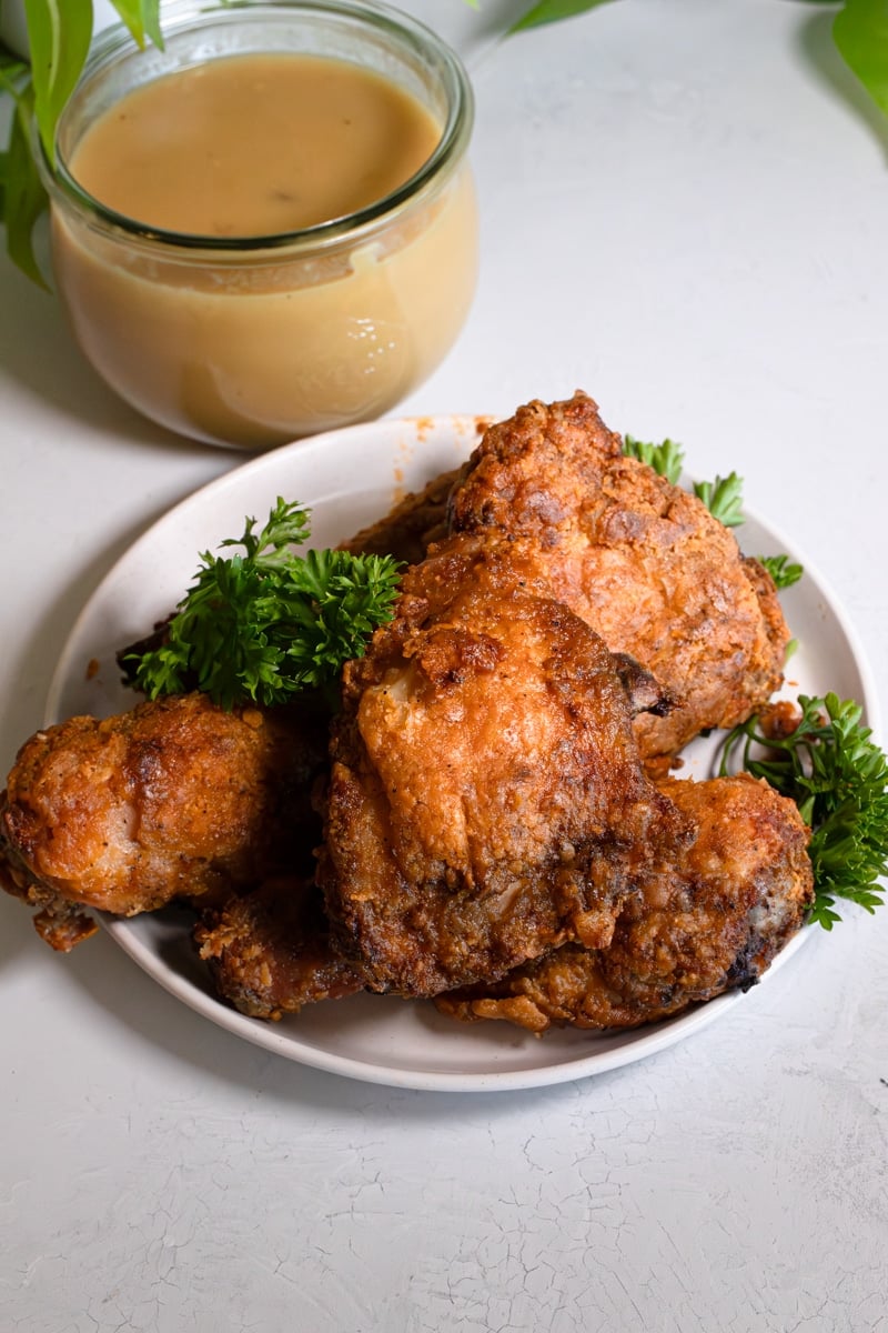 Fried chicken aka jollibee served with a side of homemade gravy.