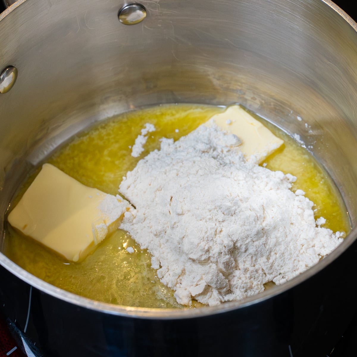 Butter and flour melting together in a pot to start the gravy
