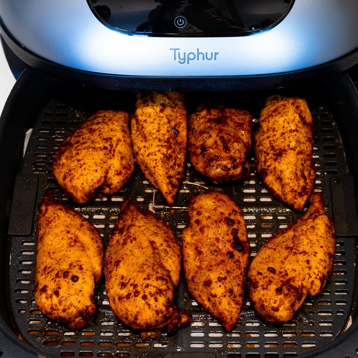 Golden cooked air fryer chicken breasts in the basket after air frying