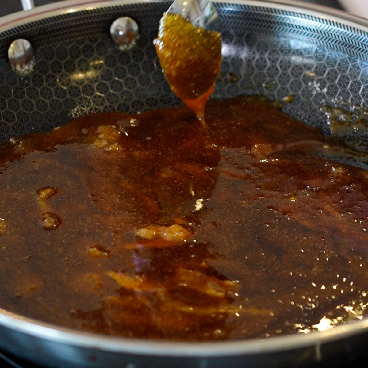 Golden caramel cooking in saute pan for leche flan